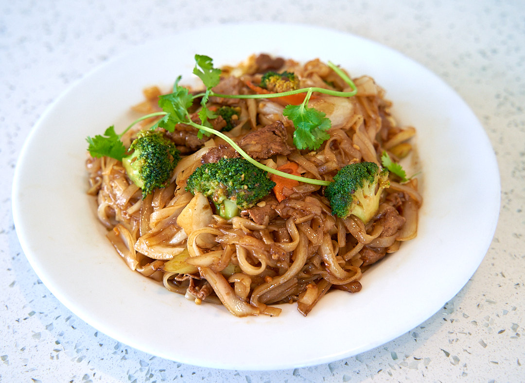 Stir-fried Beef Chow Fun with wide rice noodles and vegetables